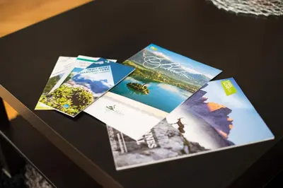 a table topped with brochures on top at Apartma Ela in Bled