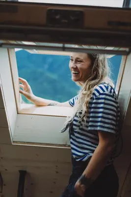 a woman looking out the window of a boat at Apartma 10th Mountain, Bovec in Bovec