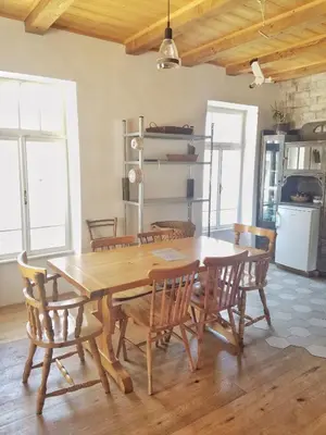 a dining room with a wooden table and chairs at Apartma 10th Mountain, Bovec in Bovec