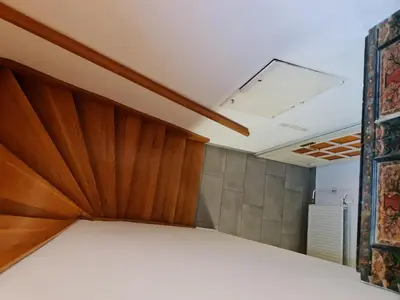 a bedroom with a bed with a wooden headboard at Holiday House Jasna in Kranjska Gora