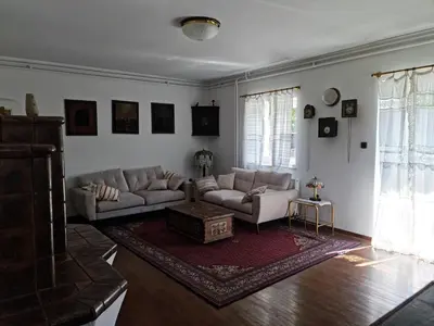 a living room with two couches and a rug at Holiday House Jasna in Kranjska Gora