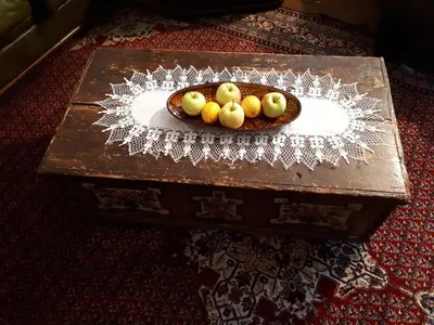 a bowl of fruit sitting on a wooden table at Holiday House Jasna in Kranjska Gora
