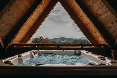 a bath tub in a cabin with a window at Lavender Hill, Eko Resort & Wellness in Polzela
