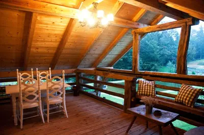 a room with two chairs and a table in a cabin at Lavender Hill, Eko Resort & Wellness in Polzela