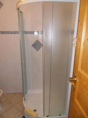 a shower with a glass door in a bathroom at Apartma Slavc in Kranjska Gora