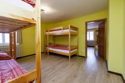 a room with two bunk beds and a hallway at House Budkovič in Bohinj