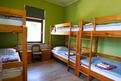 a room with four bunk beds and a window at House Budkovič in Bohinj