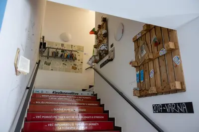 a stairway with red stairs and a wall at Hostel Pekarna in Maribor