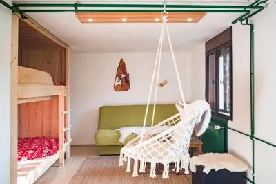 a room with two bunk beds and a swing at Nature nook in Bled