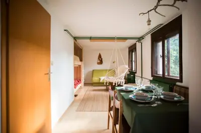 a dining room with a green table and chairs at Nature nook in Bled