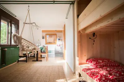 a bedroom with a loft bed and a swing at Nature nook in Bled
