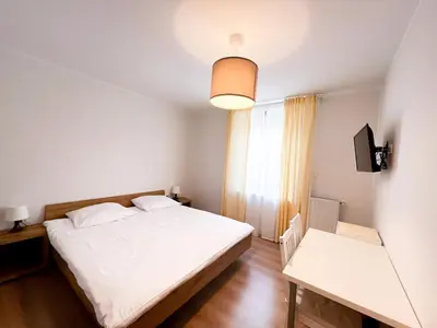 a bedroom with a white bed and a window at HOP HOUSE Garni Hotel in Postojna