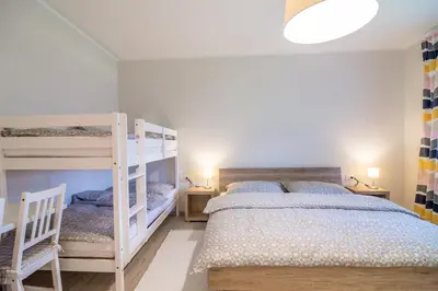 a bedroom with two bunk beds and two lamps at HOP HOUSE Garni Hotel in Postojna