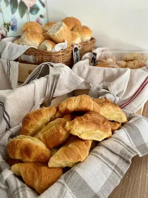 a bunch of breads in baskets on a table at HOP HOUSE Garni Hotel in Postojna