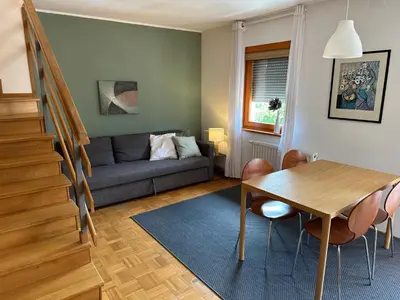 a living room with a table and a couch at Apartments Rombon in Bovec