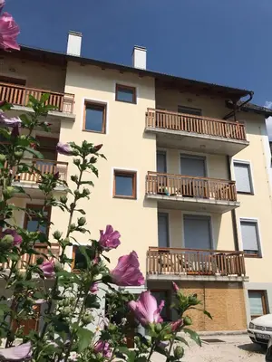 an apartment building with balconies and flowers at Apartments Rombon in Bovec