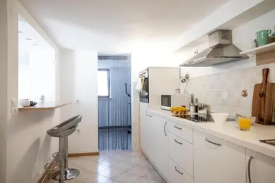 a kitchen with white cabinets and a counter top at Nauportus in Vrhnika