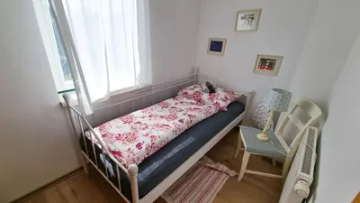 a bed in a small room with a window at Moja Vila Bled in Bled