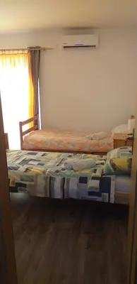 a bedroom with two beds and a window at Relax in Črni Kal 2 in Črni Kal