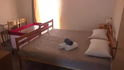a stuffed animal is sitting on a bed at Relax in Črni Kal 2 in Črni Kal