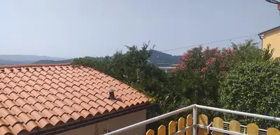 a view of a roof of a house with trees at Relax in Črni Kal 2 in Črni Kal