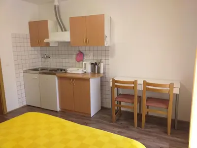 a small kitchen with a table and two chairs at Relax in Črni Kal 2 in Črni Kal