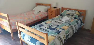 a bedroom with a bed and a dresser with two beds at Relax in Črni Kal 2 in Črni Kal