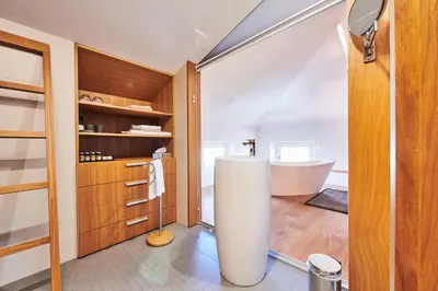 a bathroom with a bath tub and a sink at Gredič Heritage Residences in Dobrovo