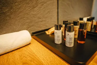a tray with three bottles of essential oils on a table at Gredič Heritage Residences in Dobrovo
