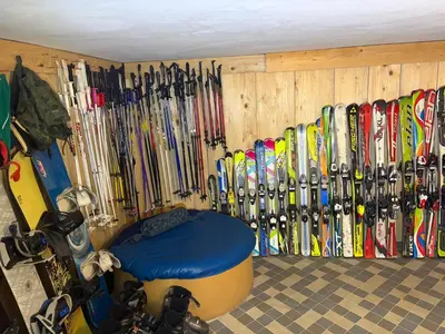 a bunch of skis are lined up against a wall at Mama's House in Cerklje na Gorenjskem