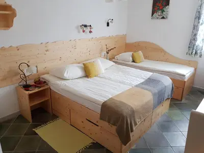 a bedroom with two beds and a night stand at Mama's House in Cerklje na Gorenjskem