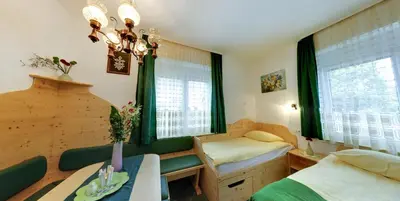 a room with a bed and a table and a room with a bed at Mama's House in Cerklje na Gorenjskem