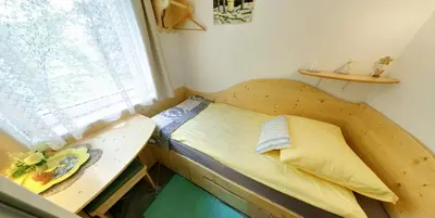 a small bedroom with a bed and a window at Mama's House in Cerklje na Gorenjskem