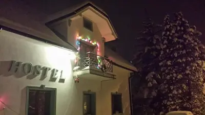 a building with a balcony with christmas lights on it at Mama's House in Cerklje na Gorenjskem