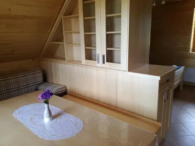 a room with a table with a vase of flowers on it at Apartmaji Vrhovnik in Cerklje na Gorenjskem