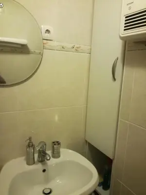 a bathroom with a white sink and a mirror at Apartmaji Vrhovnik in Cerklje na Gorenjskem
