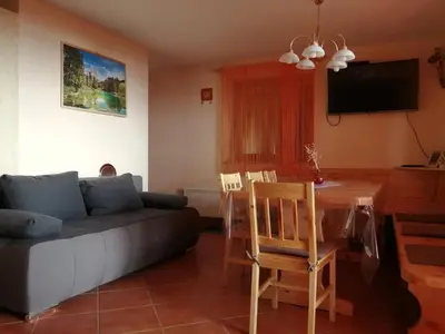 a living room with a couch and a table at Apartmaji Vrhovnik in Cerklje na Gorenjskem