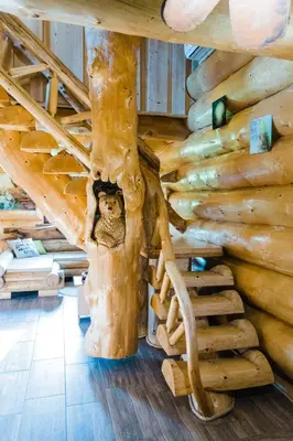 a room with a staircase in a log cabin at Forest Glade Cottage - Koča na jasi in Rečica ob Savinji