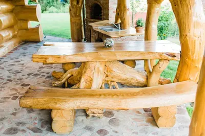 a wooden table and bench in a yard at Forest Glade Cottage - Koča na jasi in Rečica ob Savinji