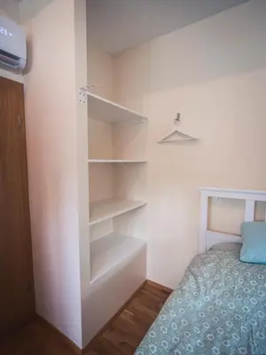 a bedroom with a bed and a book shelf at Studio Kolman in Bled