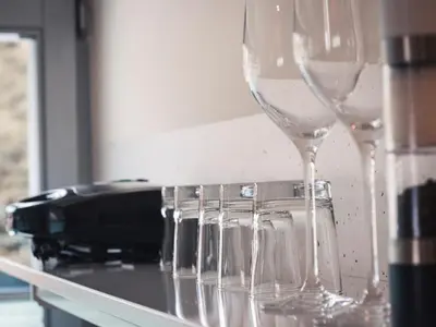 a row of wine glasses sitting on a counter at Studio Kolman in Bled