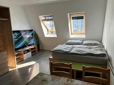 a small room with a bed and a flat screen tv at Apartment Aly in Bovec