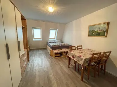 a room with a bed and a table and chairs at Apartment Aly in Bovec