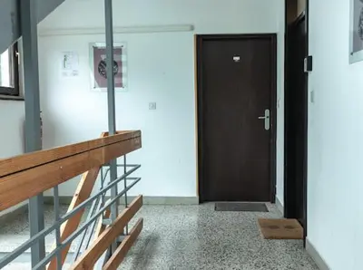 a hallway with a wooden door and a wooden bench at Apartment Aly in Bovec