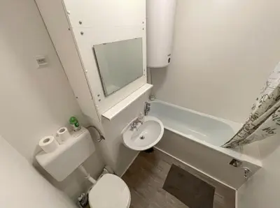 a small bathroom with a toilet and a sink at Apartment Aly in Bovec
