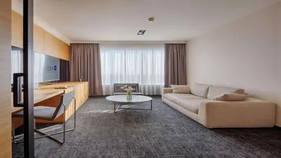 a living room with a couch and a table at Radisson Blu Plaza Hotel Ljubljana in Ljubljana