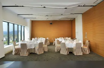 a room with tables and chairs with white tablecloths at Radisson Blu Plaza Hotel Ljubljana in Ljubljana