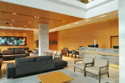 a lobby with couches and chairs and a bar at Radisson Blu Plaza Hotel Ljubljana in Ljubljana