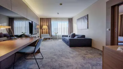 a living room with a couch and a table at Radisson Blu Plaza Hotel Ljubljana in Ljubljana
