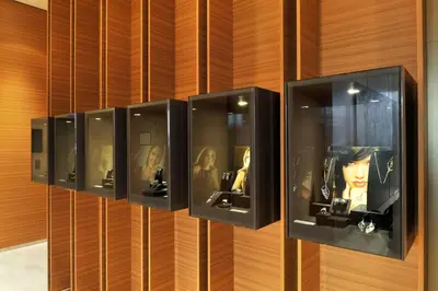 a wall with a row of display cases with dolls at Radisson Blu Plaza Hotel Ljubljana in Ljubljana